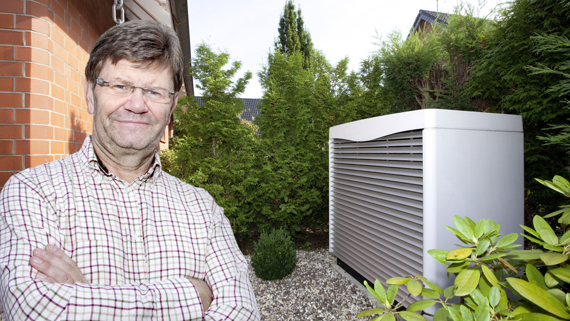 Man in front of a heat pump