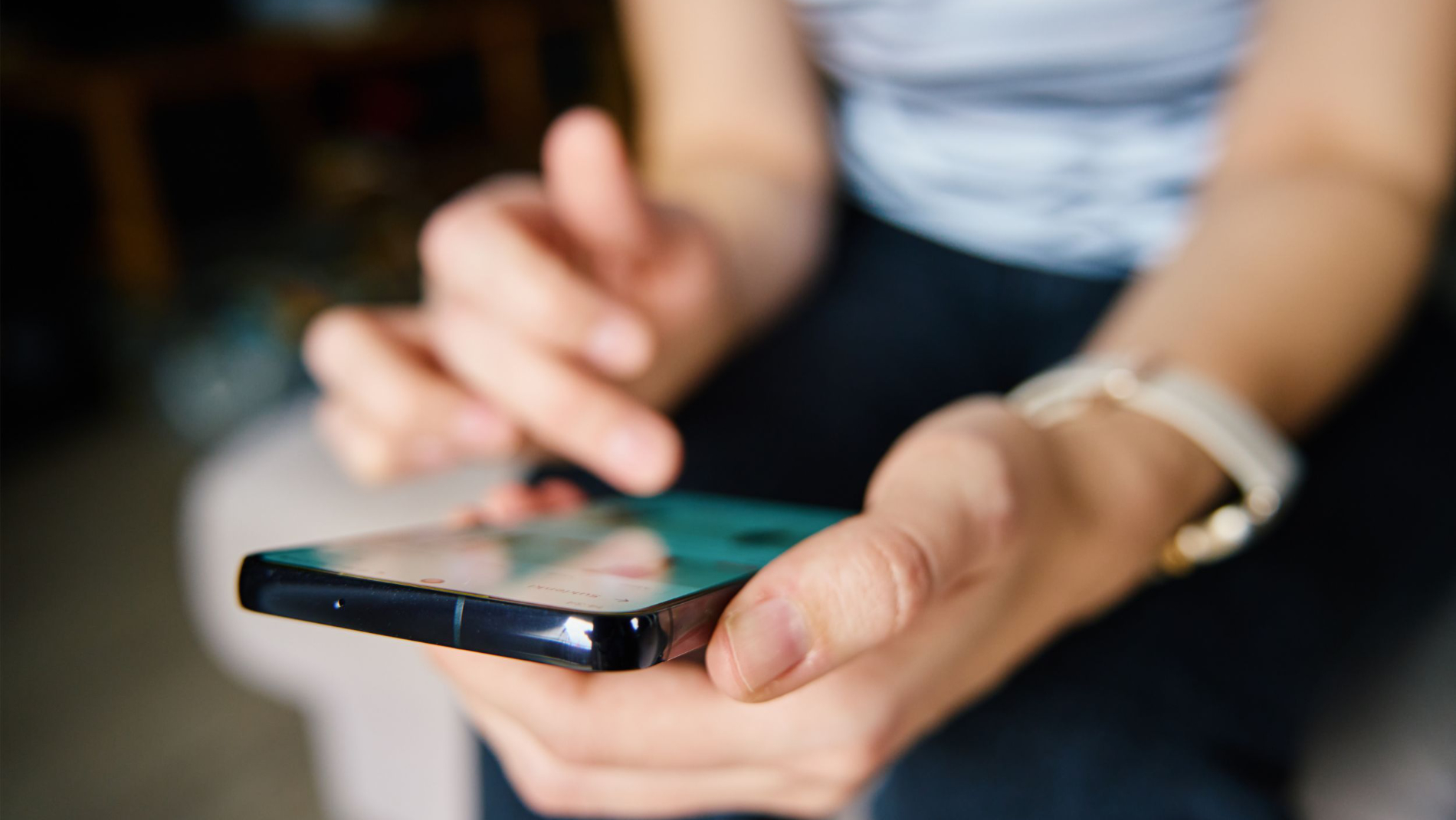A woman holding a smartphone in her hand