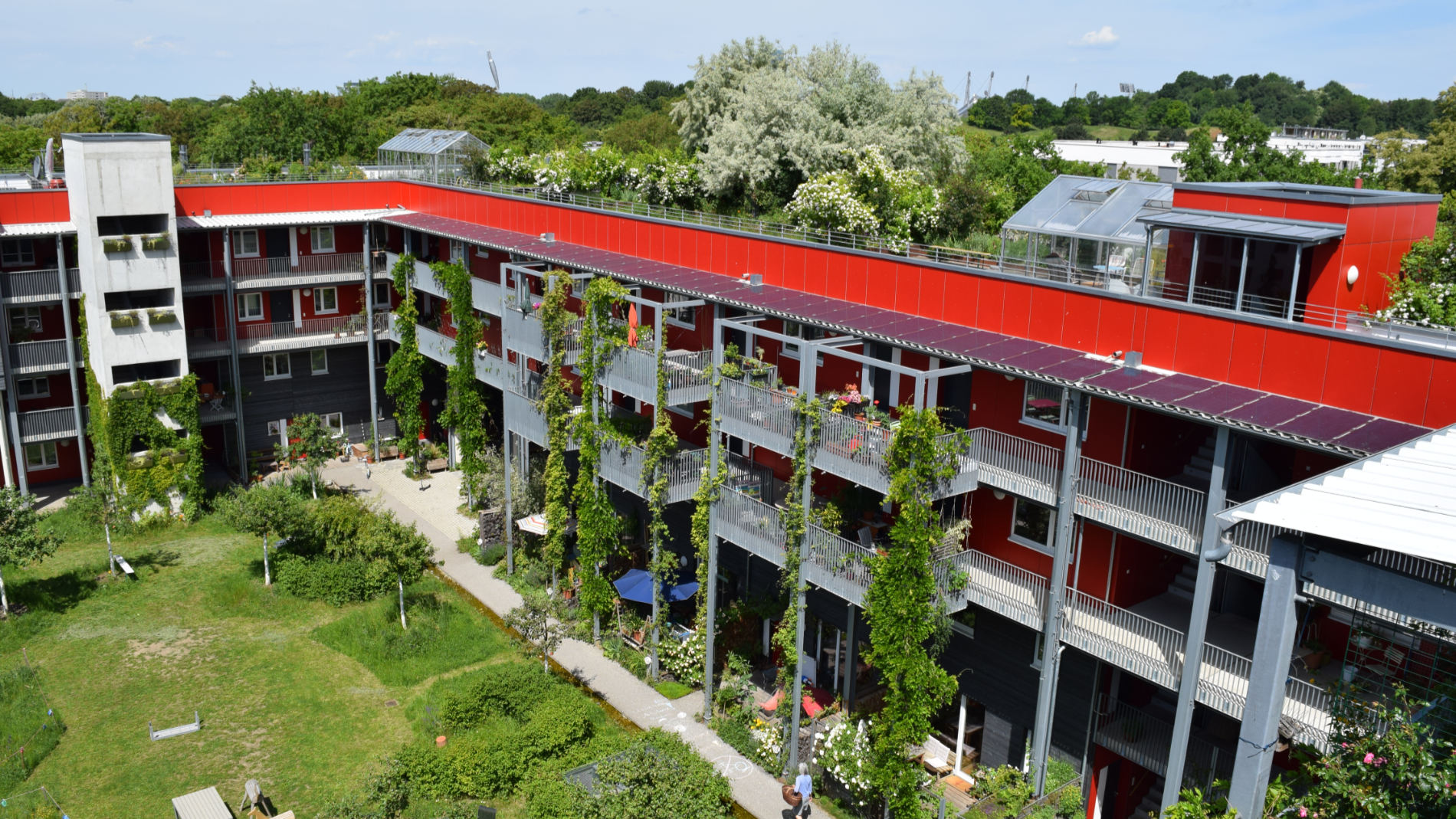 Apartment block with green roof and façade