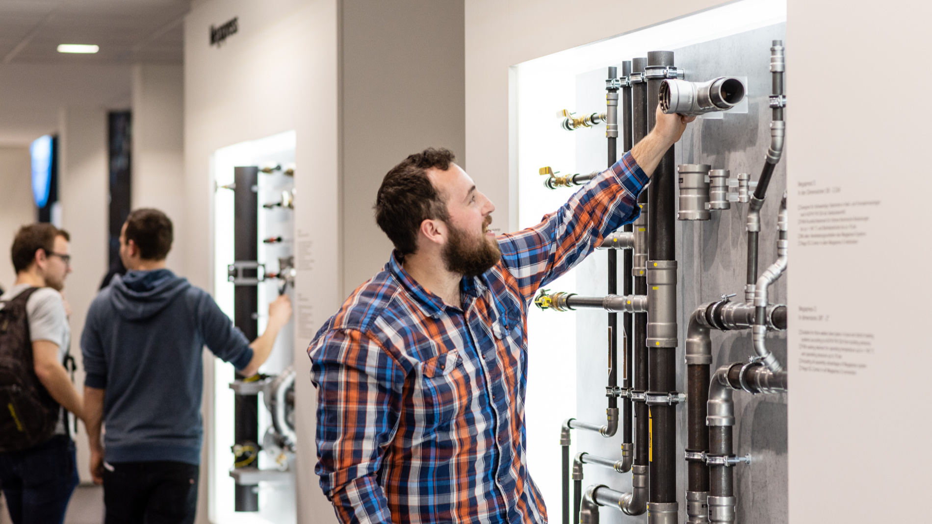 Mann looks at a model of a water-bearing system for service and rainwater utilisation