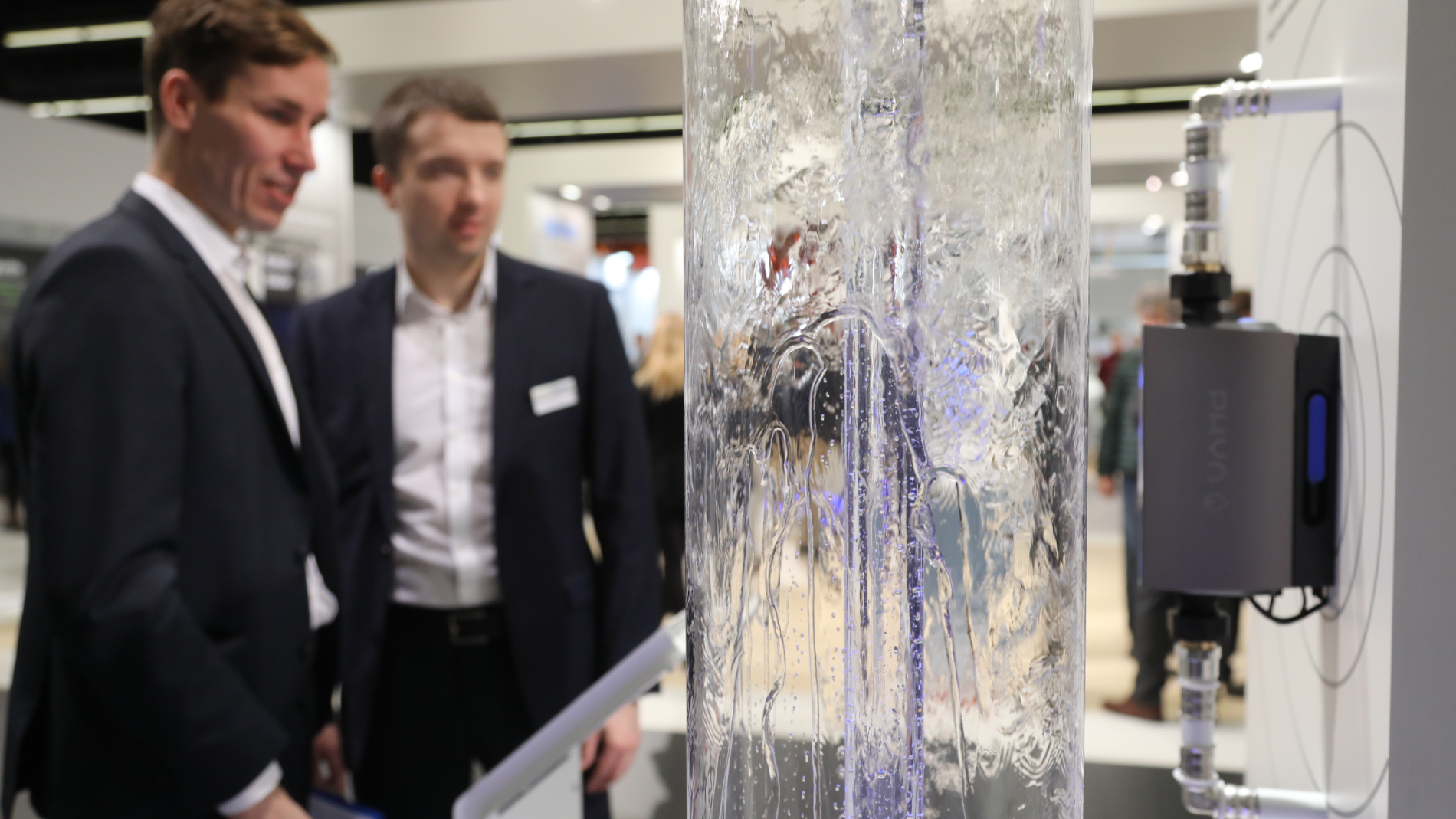 Two men look at a drinking water circuit